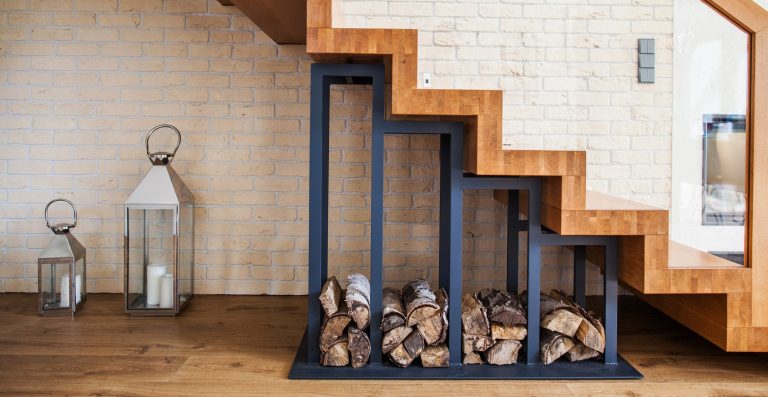 modern solution to storage pile of wood under the stairs at home
